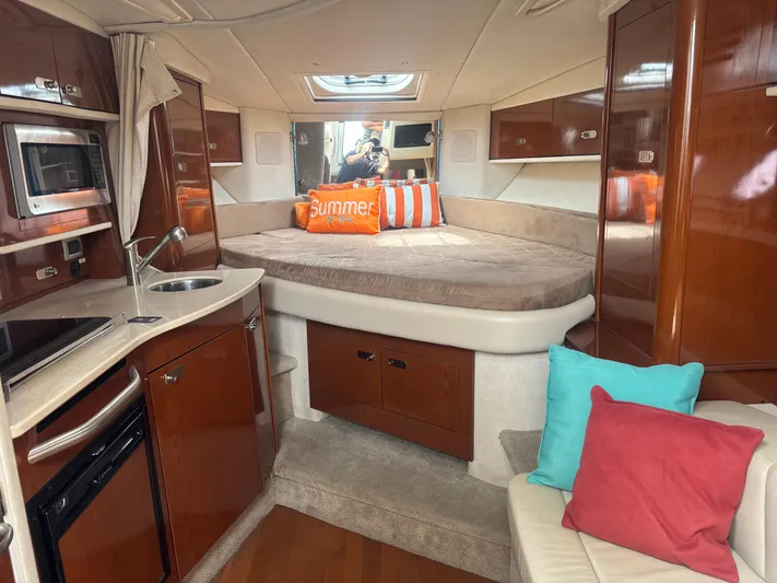 Summer Of Bob Yacht Photos Pics Interior of 2011 Sea Ray 330 Sundancer yacht with cozy bed and kitchenette.