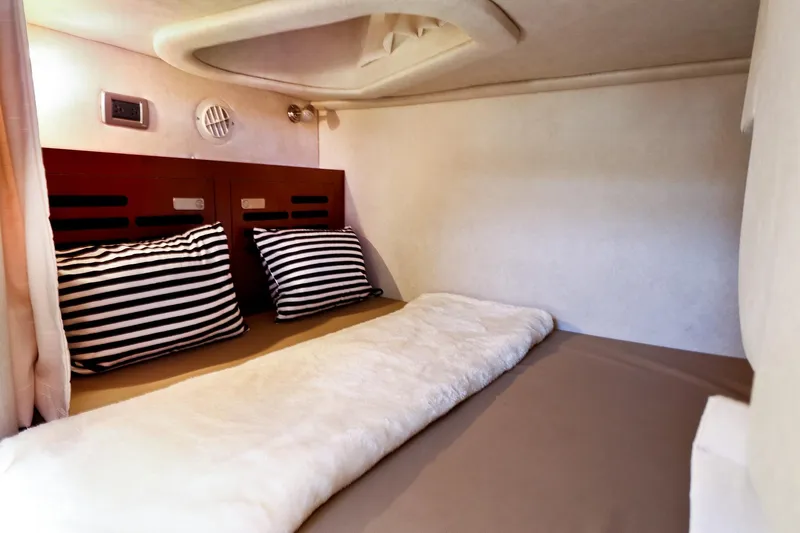 St Babyn Yacht Photos Pics Cozy cabin interior of 2012 Sea Ray Sundancer 310 with striped pillows and soft bedding.