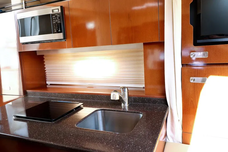 St Babyn Yacht Photos Pics Modern kitchen area in 2012 Sea Ray Sundancer 310 yacht with sink, stove, and microwave.