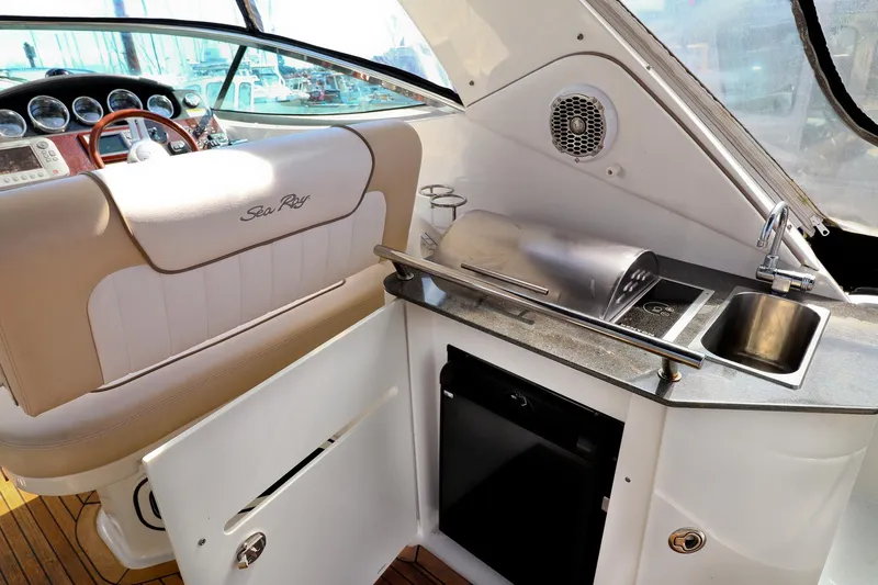 St Babyn Yacht Photos Pics 2012 Sea Ray Sundancer 310 cockpit with helm, sink, and mini fridge.