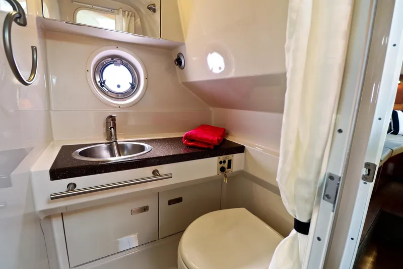 St Babyn Yacht Photos Pics 2012 Sea Ray Sundancer 310 bathroom with sink, porthole, and red towel.
