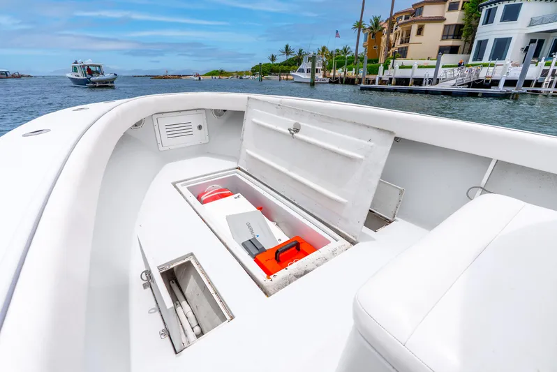  Yacht Photos Pics Open storage compartment on 2018 Ocean Runner 29 boat, docked near waterfront homes.