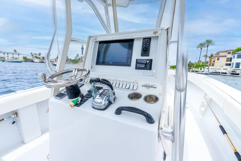  Yacht Photos Pics 2018 Ocean Runner 29 boat console with steering wheel and navigation equipment.