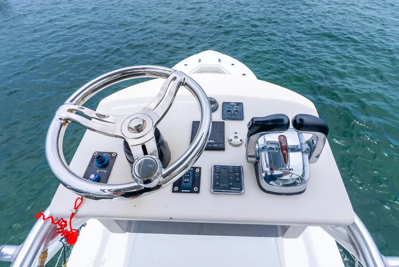  Yacht Photos Pics Steering console of 2018 Ocean Runner 29 boat with controls and chrome wheel.