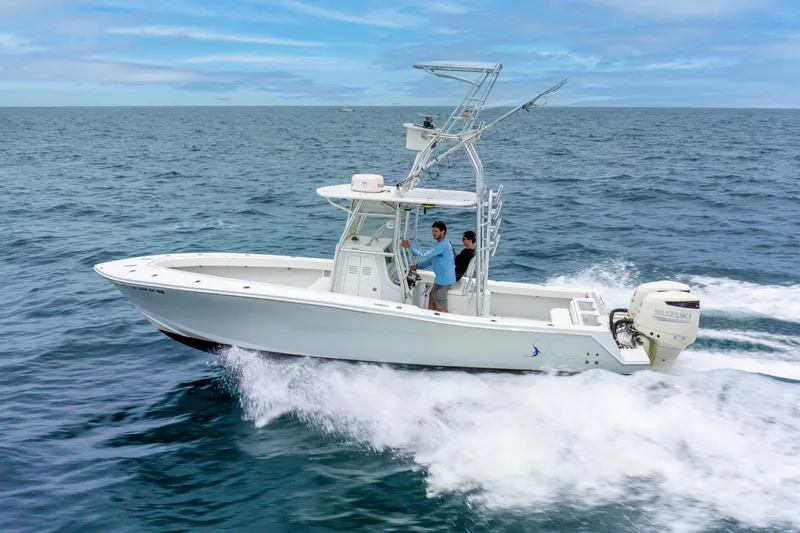  Yacht Photos Pics 2018 Ocean Runner 29 boat cruising on open sea with two passengers.