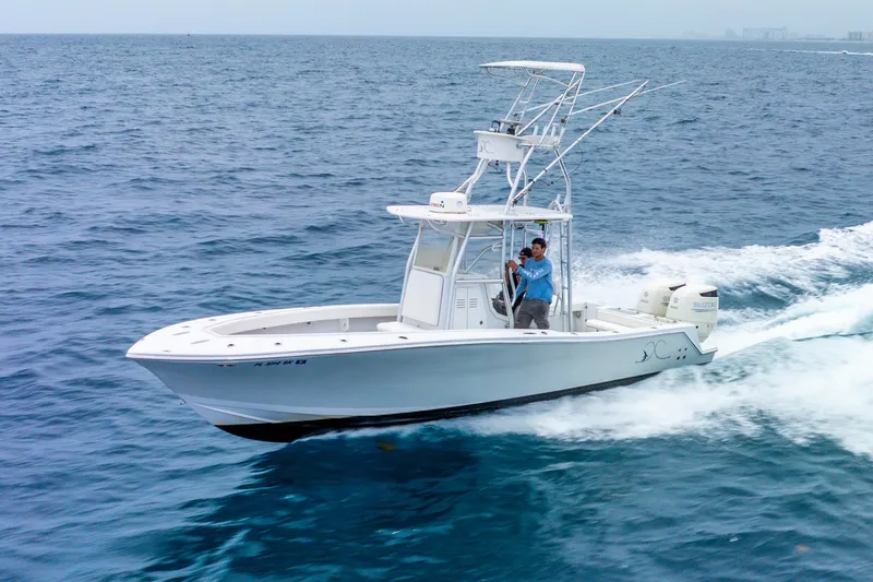  Yacht Photos Pics 2018 Ocean Runner 29 boat cruising on open sea with two passengers.