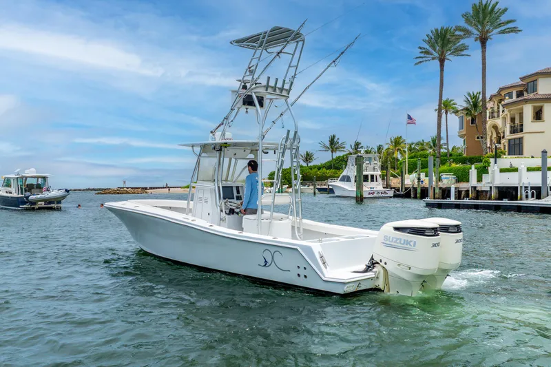  Yacht Photos Pics 2018 Ocean Runner 29 boat cruising near a marina with palm trees and clear skies.