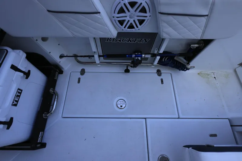  Yacht Photos Pics 2023 Blackfin 252 DC boat interior with Yeti cooler and fishing rod storage.