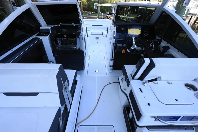  Yacht Photos Pics 2023 Blackfin 252 DC boat interior with modern seating and navigation equipment.