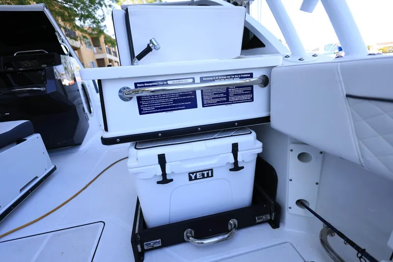  Yacht Photos Pics 2023 Blackfin 252 DC boat interior with Yeti cooler and storage compartment.