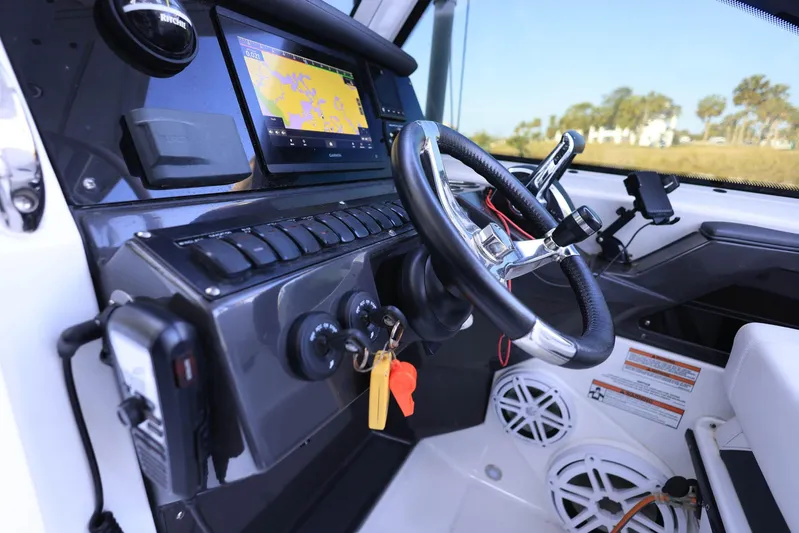  Yacht Photos Pics 2023 Blackfin 252 DC boat dashboard with steering wheel and navigation display.