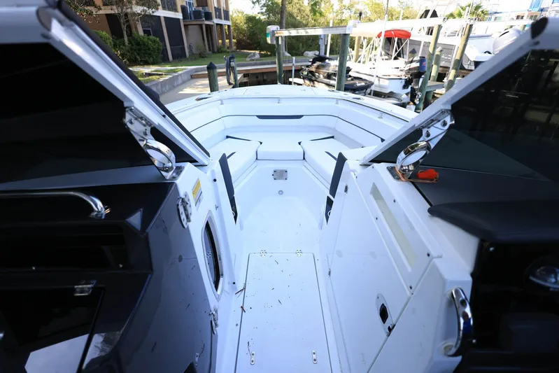  Yacht Photos Pics 2023 Blackfin 252 DC boat interior with open storage compartments and seating area.