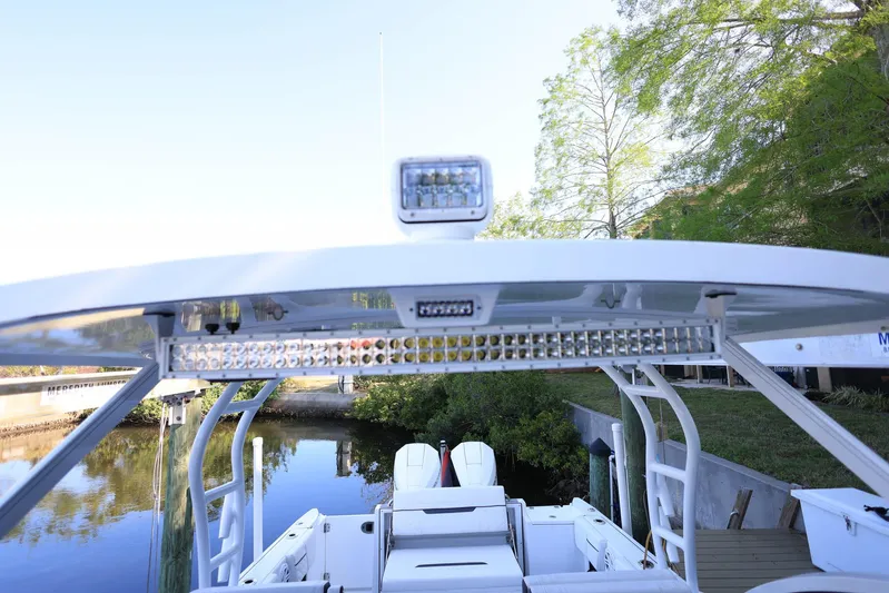  Yacht Photos Pics 2023 Blackfin 252 DC boat with LED lights, docked by a serene lakeside.