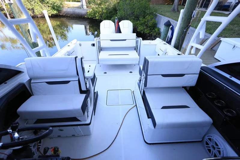  Yacht Photos Pics 2023 Blackfin 252 DC boat interior with white seating and sleek design.