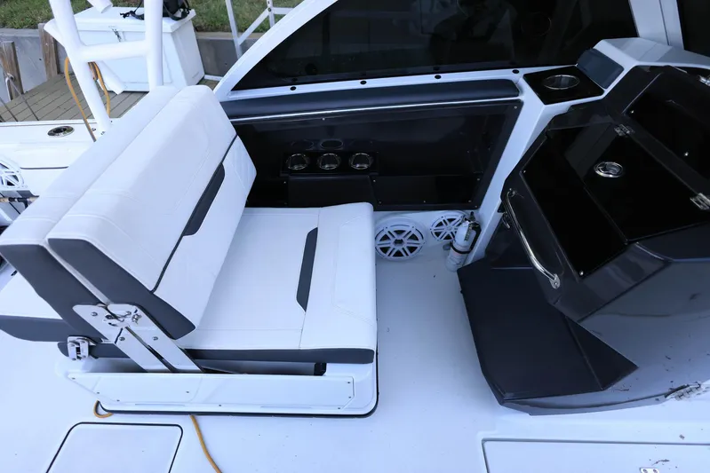  Yacht Photos Pics 2023 Blackfin 252 DC boat interior with white seating and modern dashboard.
