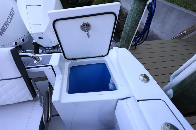  Yacht Photos Pics 2023 Blackfin 252 DC boat with open storage compartment and Mercury engine.