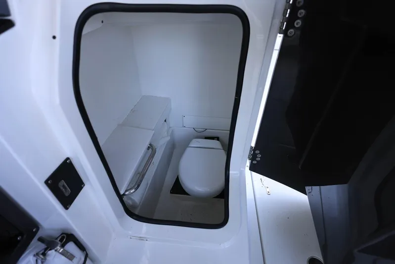  Yacht Photos Pics 2023 Blackfin 252 DC boat interior with compact marine toilet.