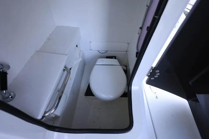  Yacht Photos Pics 2023 Blackfin 252 DC boat interior bathroom with toilet and handrail.