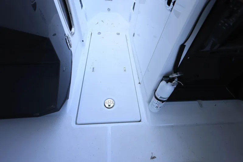  Yacht Photos Pics 2023 Blackfin 252 DC boat interior with storage hatch and fire extinguisher.