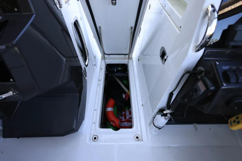  Yacht Photos Pics 2023 Blackfin 252 DC boat storage compartment with safety equipment and gear.