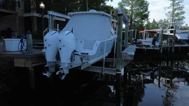  Yacht Photos Pics 2023 Blackfin 252 DC boat with dual engines docked at a marina.