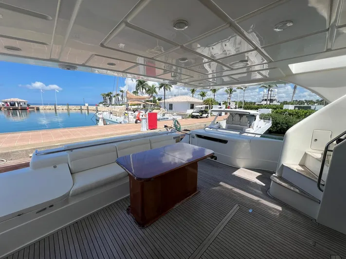 Amia Yacht Photos Pics 2006 Ferretti Yachts 731 aft deck with seating and table, docked at marina.