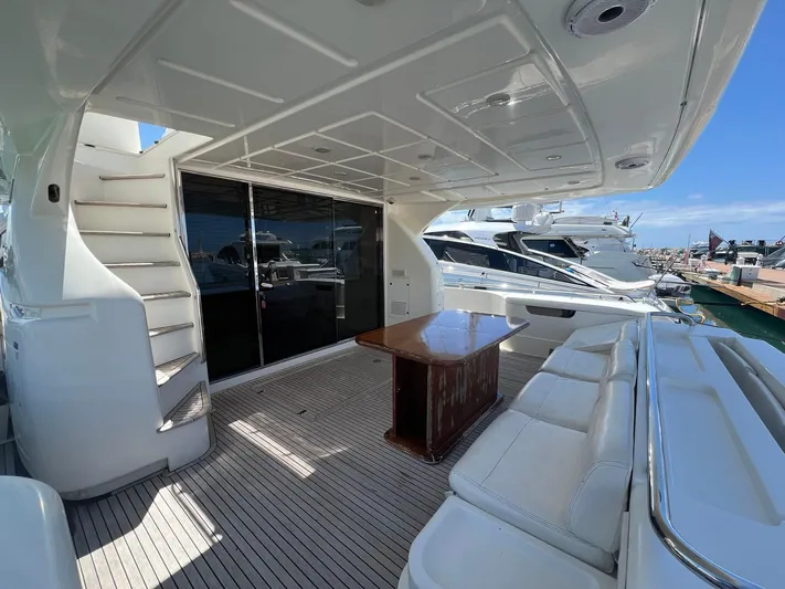 Amia Yacht Photos Pics 2006 Ferretti Yachts 731 aft deck with seating, table, and staircase.