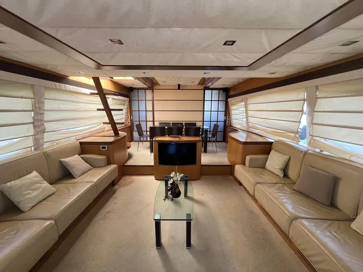 Amia Yacht Photos Pics Luxurious interior of a 2006 Ferretti Yachts 731 with beige leather sofas and a glass coffee table.
