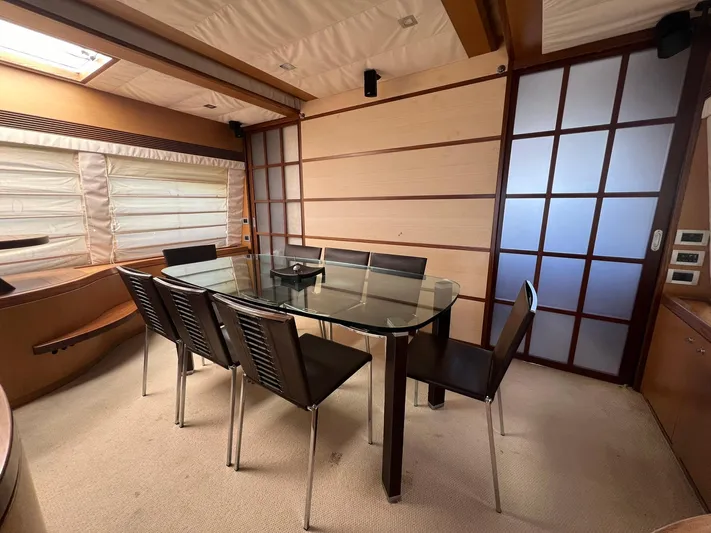 Amia Yacht Photos Pics Elegant dining area in 2006 Ferretti Yachts 731 with glass table and modern chairs.