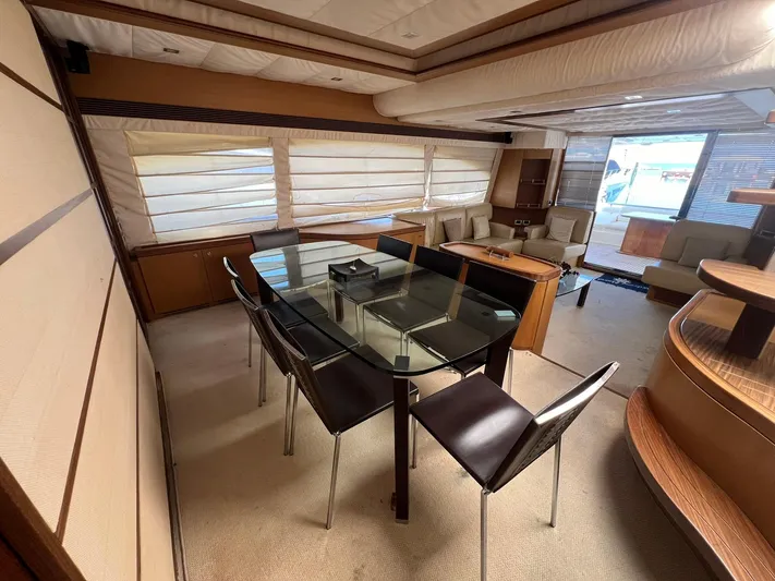 Amia Yacht Photos Pics Interior of 2006 Ferretti Yachts 731 with modern dining area and glass table.