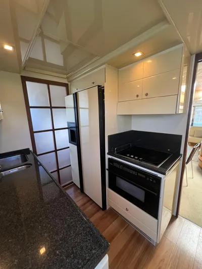 Amia Yacht Photos Pics 2006 Ferretti Yachts 731 kitchen with modern appliances and sleek design.