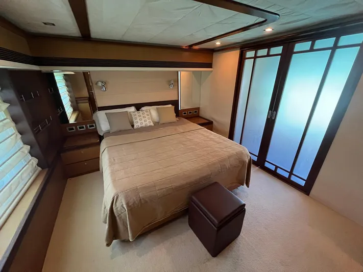 Amia Yacht Photos Pics Luxurious bedroom interior of 2006 Ferretti Yachts 731 with modern design and ample storage.
