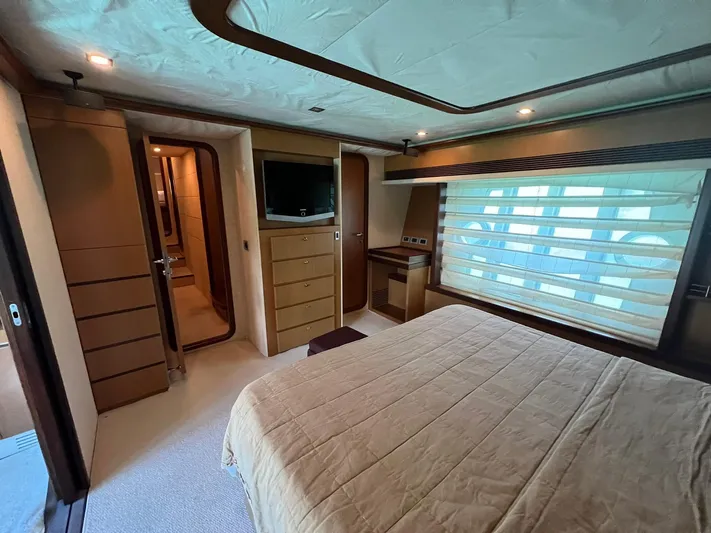 Amia Yacht Photos Pics Luxurious bedroom interior of 2006 Ferretti Yachts 731 with modern amenities and elegant design.