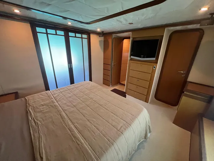 Amia Yacht Photos Pics Luxurious bedroom in 2006 Ferretti Yachts 731 with modern furnishings and ample storage.