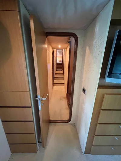 Amia Yacht Photos Pics Interior hallway of a 2006 Ferretti Yachts 731, featuring wooden doors and cabinetry.