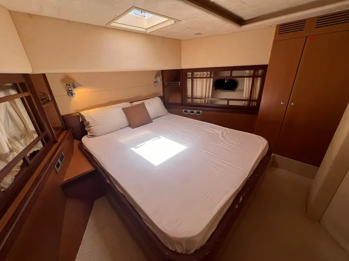 Amia Yacht Photos Pics Luxurious bedroom in a 2006 Ferretti Yachts 731 with skylight and modern furnishings.