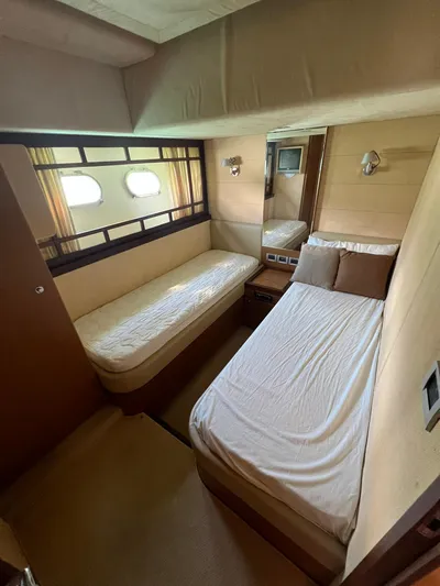 Amia Yacht Photos Pics 2006 Ferretti Yachts 731 cabin with twin beds and porthole windows.