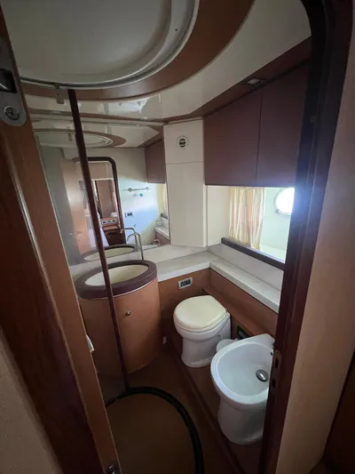 Amia Yacht Photos Pics Bathroom interior of a 2006 Ferretti Yachts 731, featuring modern fixtures and wooden cabinetry.