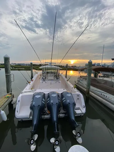  Yacht Photos Pics 2014 Grady-White Canyon 376 boat docked at sunset with triple outboard engines.