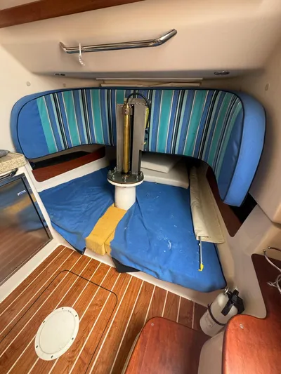  Yacht Photos Pics 2014 Grady-White Canyon 376 cabin interior with striped cushions and wooden flooring.