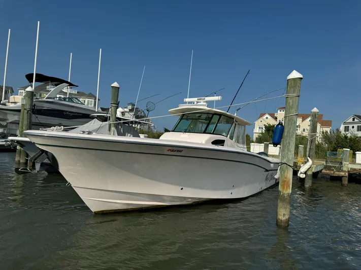  Yacht Photos Pics 2014 Grady-White Canyon 376 boat docked at marina under clear blue sky.