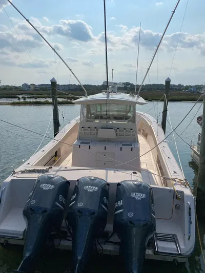  Yacht Photos Pics 2014 Grady-White Canyon 376 boat with triple Yamaha engines docked in a marina.