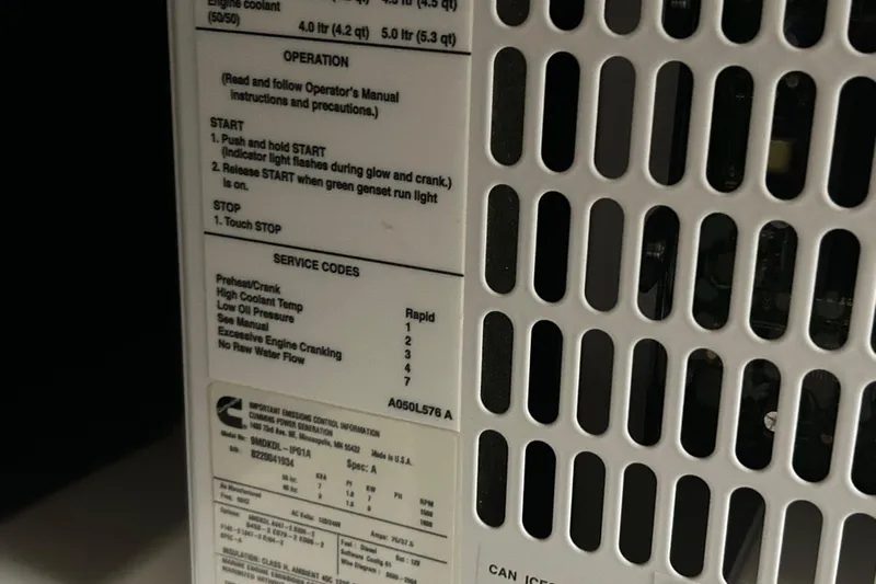 Esc Key Yacht Photos Pics Close-up of a Cummins generator panel with operation instructions and service codes.