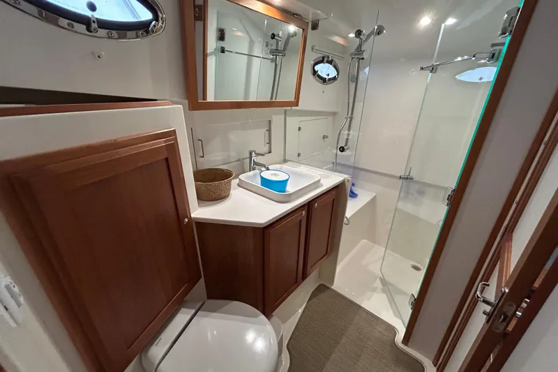 Esc Key Yacht Photos Pics Luxurious bathroom in 2023 Back Cove 39O yacht with modern fixtures and wooden cabinetry.