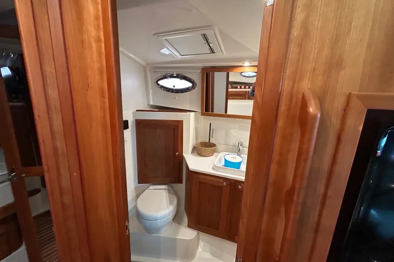 Esc Key Yacht Photos Pics 2023 Back Cove 39O yacht bathroom with wooden cabinetry and modern fixtures.