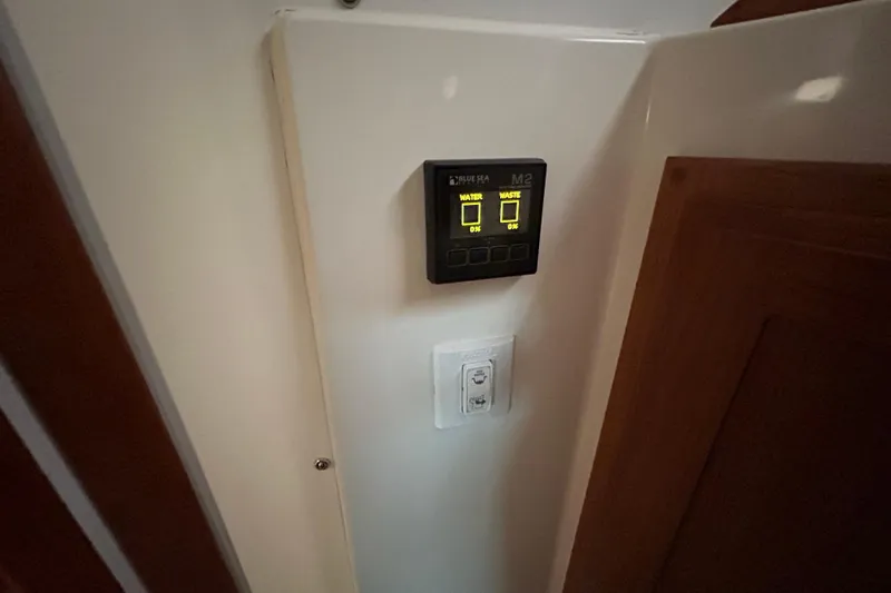 Esc Key Yacht Photos Pics Control panel inside 2023 Back Cove 39O boat, displaying water and waste levels.