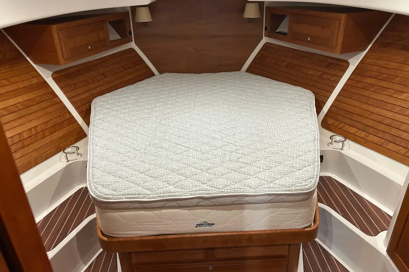 Esc Key Yacht Photos Pics 2023 Back Cove 39O cabin interior with wooden accents and a comfortable bed.