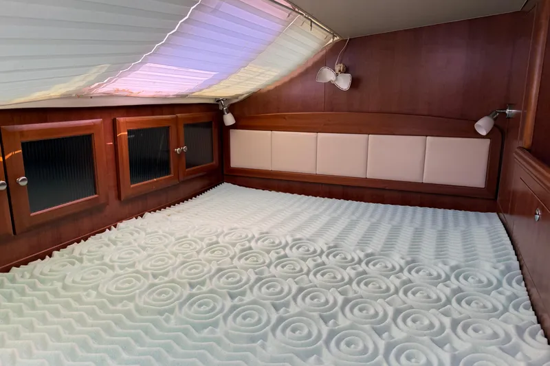 Sirenia Yacht Photos Pics Cozy cabin interior of 2014 Gemini Legacy 35 with patterned mattress and wooden cabinetry.