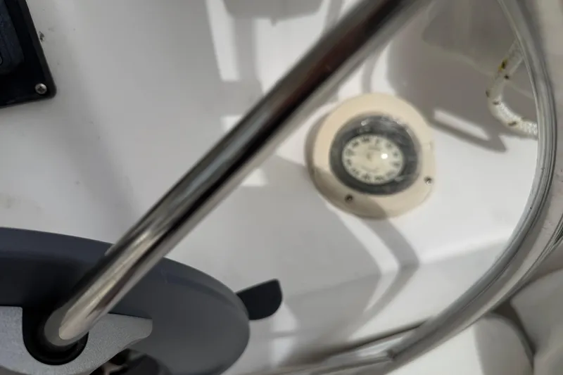 Sirenia Yacht Photos Pics Close-up of a 2014 Gemini Legacy 35 boat's steering wheel and compass.