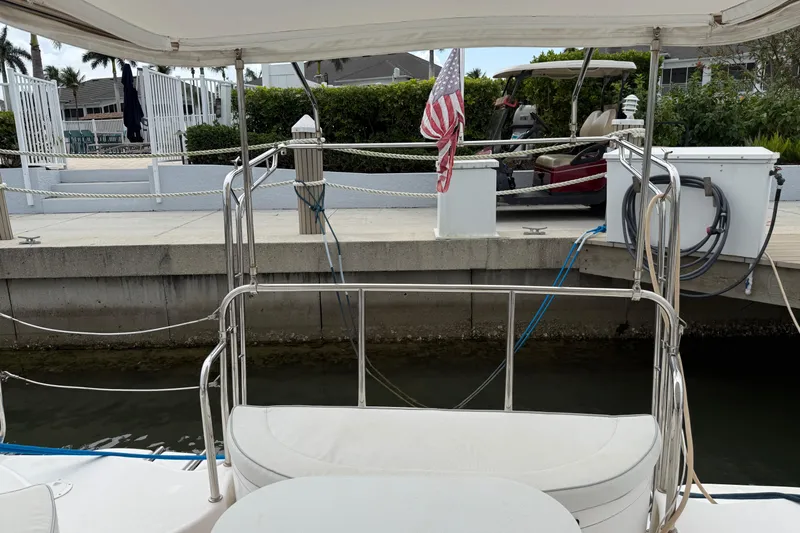 Sirenia Yacht Photos Pics Docked Gemini Legacy 35 sailboat, 2014 model, with American flag and marina view.